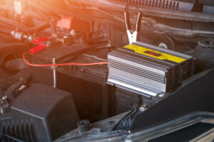 istockphoto-1295165932-612x612 Charging car battery with portable electric battery charger and jumper cables on car engine